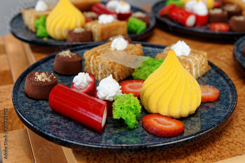 Plates with different sweets photo