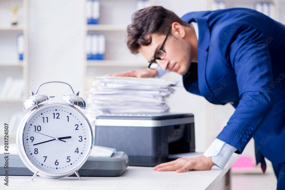 Businessman making copies in copying machine Businessman making copies in copying machine