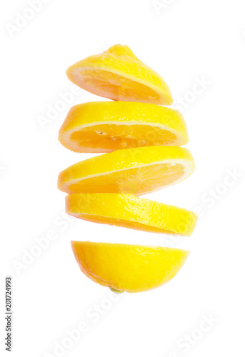 Flying lemon. Sliced lemon isolated on white background. Levity fruit