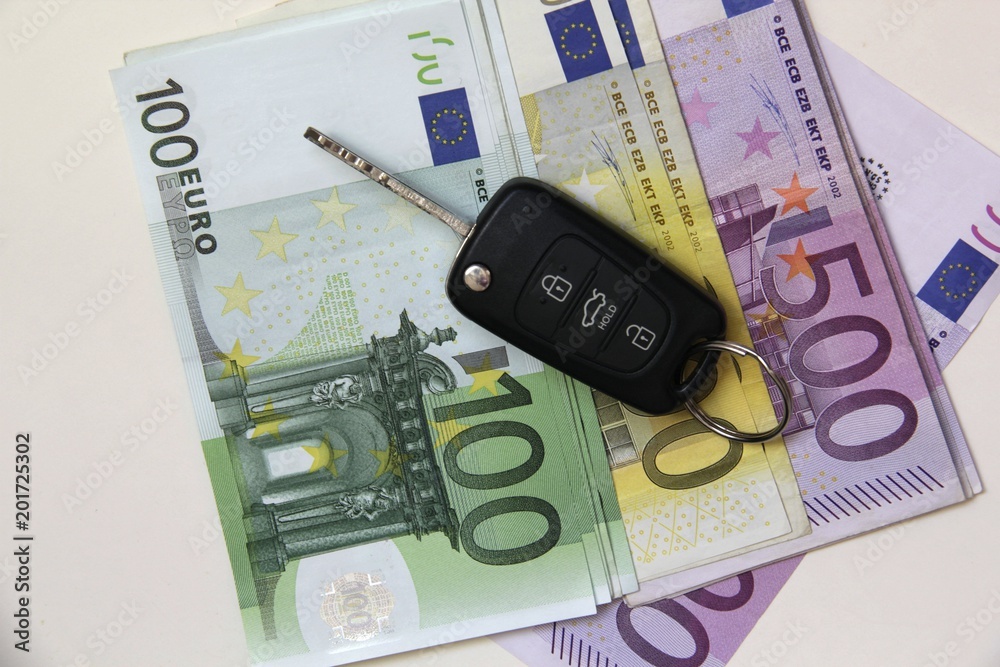 New Car key on Euro Banknotes background on Bright background. New Car key on Euro Banknotes background on Bright background.