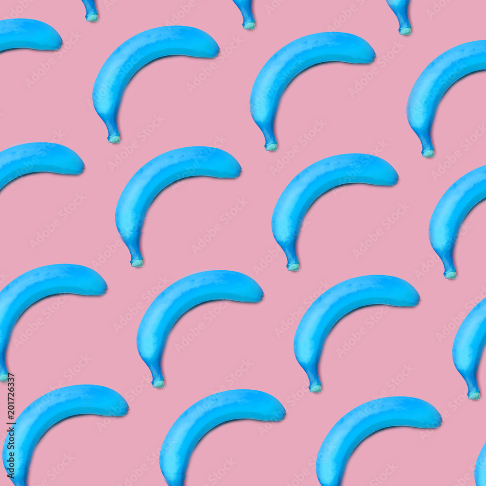 Colorful fruit pattern of blue bananas on pink background top view Colorful fruit pattern of blue bananas on pink background top view