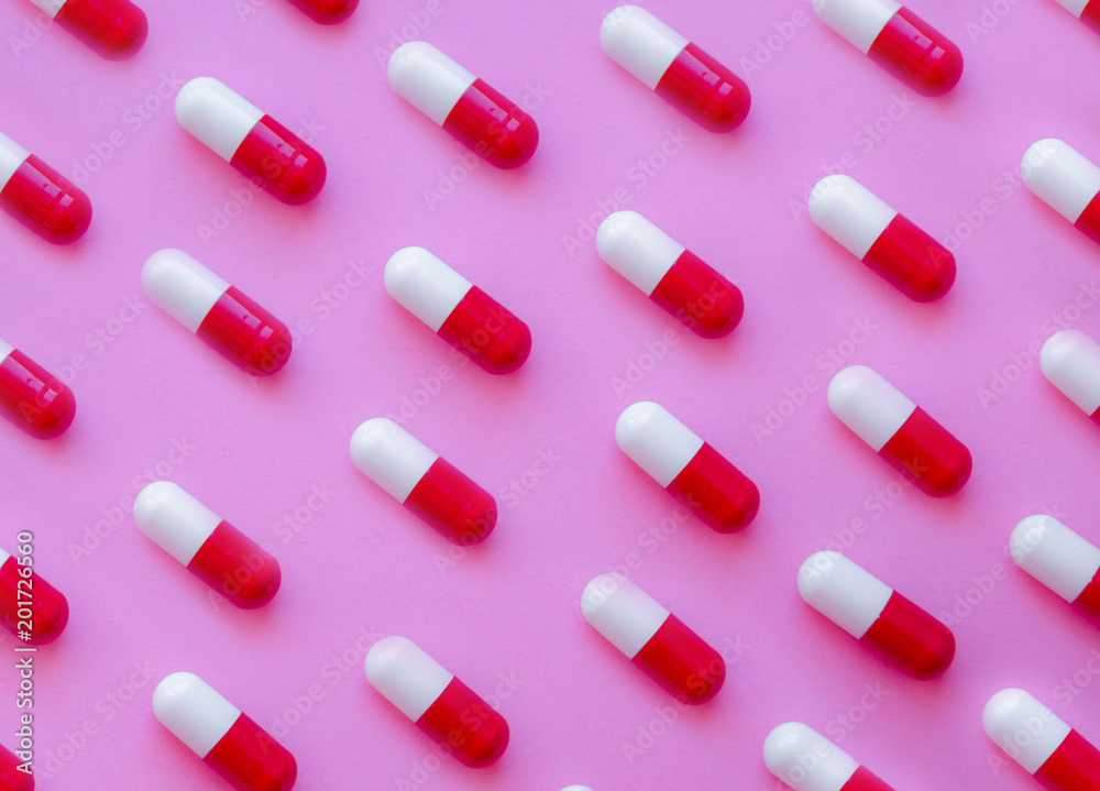 Capsule pills pattern on a pink background Capsule pills pattern on a pink background