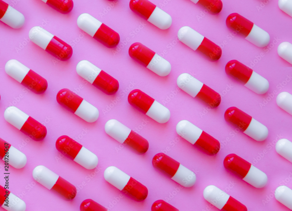 Capsule pills pattern on a pink background Capsule pills pattern on a pink background