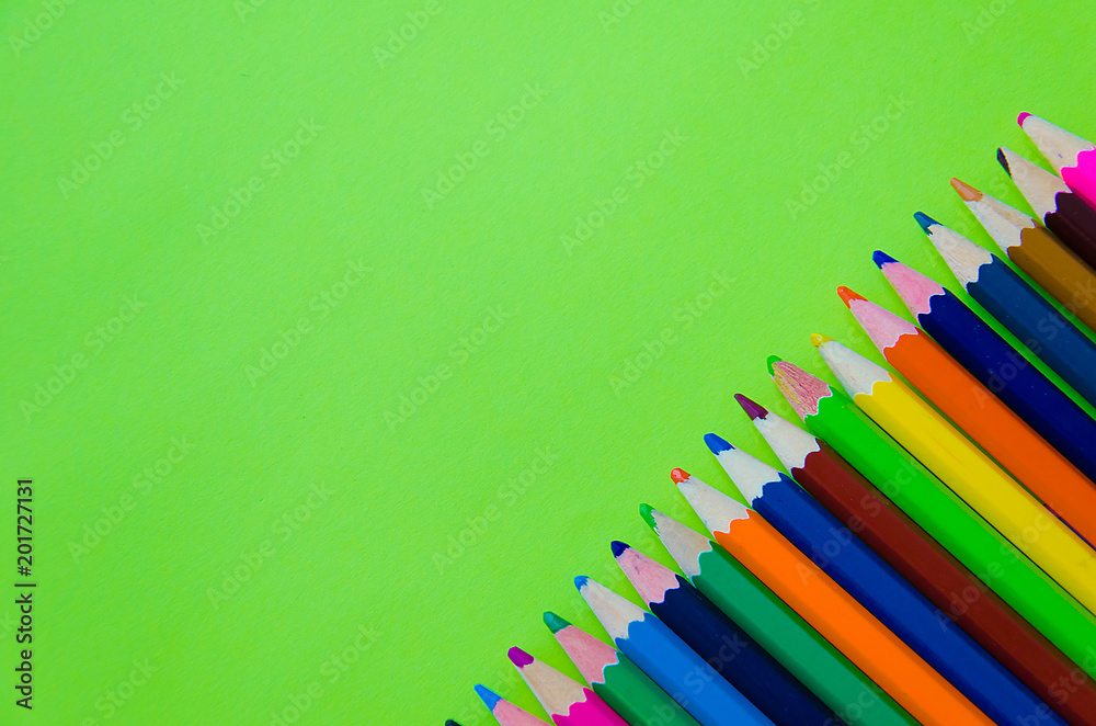 Fototapeta premium Set of colour pencils on green background 