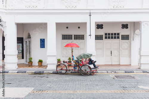 Tricycle parking infront of ancient building photo