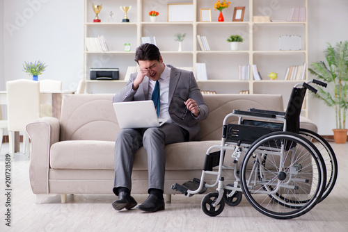 Dsabled businessman on wheelchair working home © Elnur