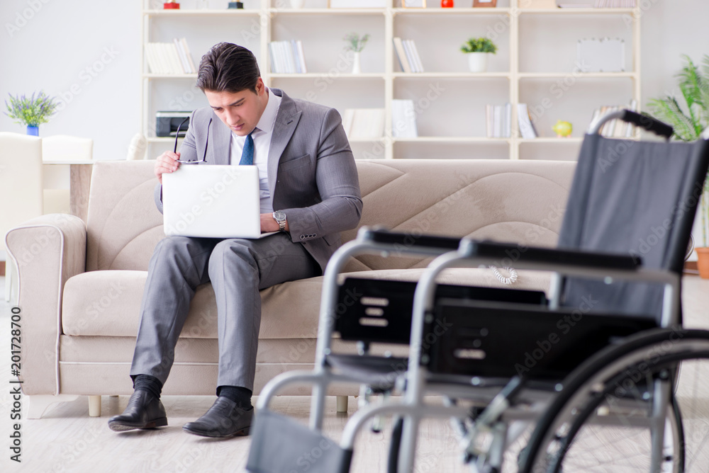 Dsabled businessman on wheelchair working home Dsabled businessman on wheelchair working home