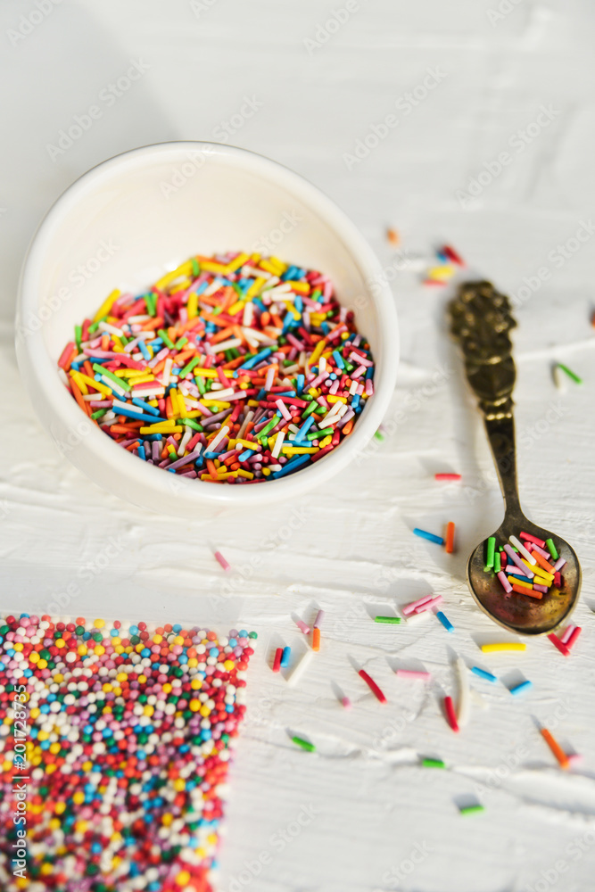 Fototapeta premium culinary sprinkling, cooking dressing in a Cup with a spoon on light background, close up