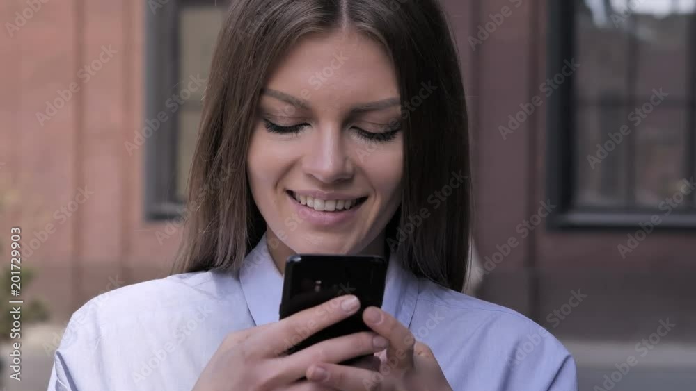 Young Woman Busy Using Smartphone, Standing Outside Office Young Woman Busy Using Smartphone, Standing Outside Office