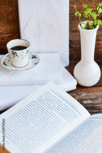 white coffee Cup and books with white covers, the concept of love of reading on table