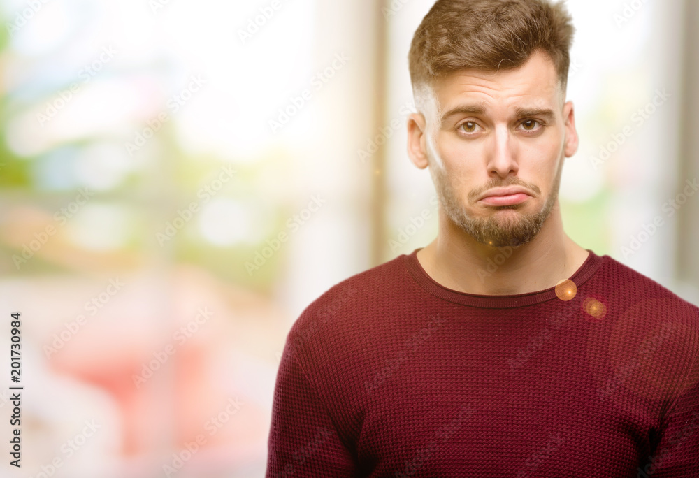 Handsome young man with sad and upset expression, unhappy Handsome young man with sad and upset expression, unhappy