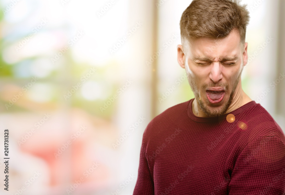 Handsome young man crying depressed full of sadness expressing sad emotion Handsome young man crying depressed full of sadness expressing sad emotion