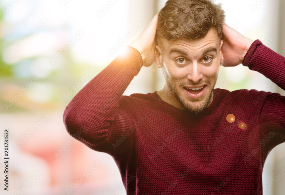 Handsome young man happy and surprised cheering expressing wow gesture