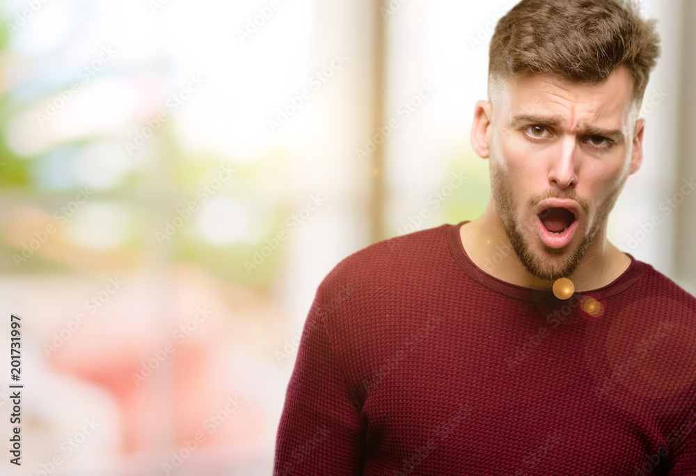 Handsome young man scared and surprised cheering expressing wow gesture. Unbelieving Handsome young man scared and surprised cheering expressing wow gesture. Unbelieving