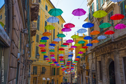 GENOA  ITALY  APRIL 16  2018 - Multicolored umbrellas in the sky above the streets in the center of Genoa  Italy.