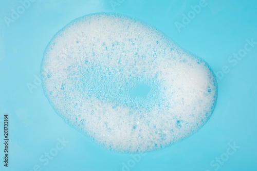 Foam bubble drop on blue background on top view object beatuy health care concept design