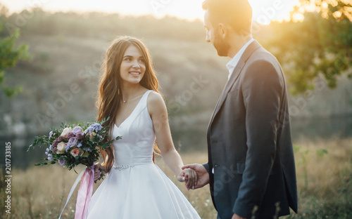 Wedding couple at the walk with mountain and river at the background