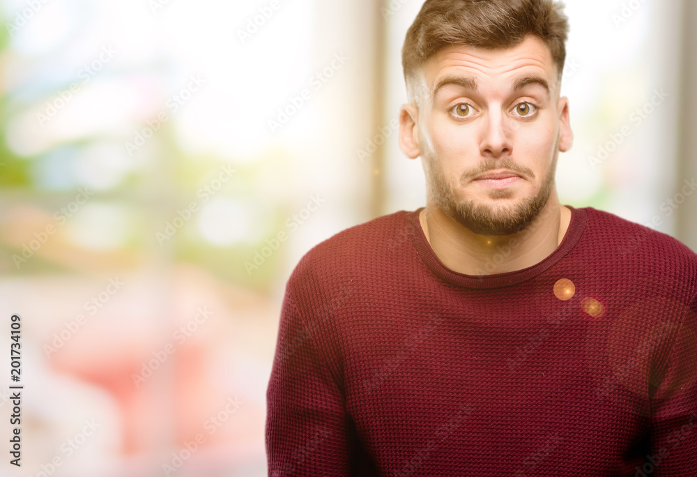 Handsome young man doubt expression, confuse and wonder concept, uncertain future Handsome young man doubt expression, confuse and wonder concept, uncertain future