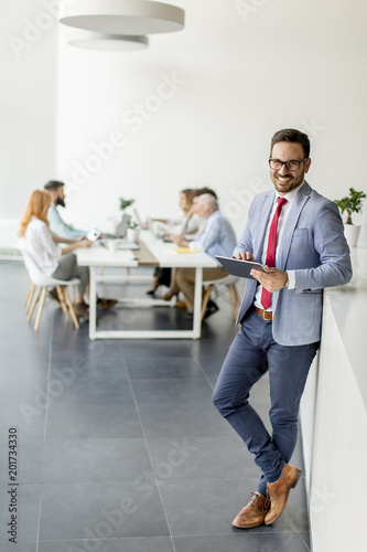 Young businessman with digi...