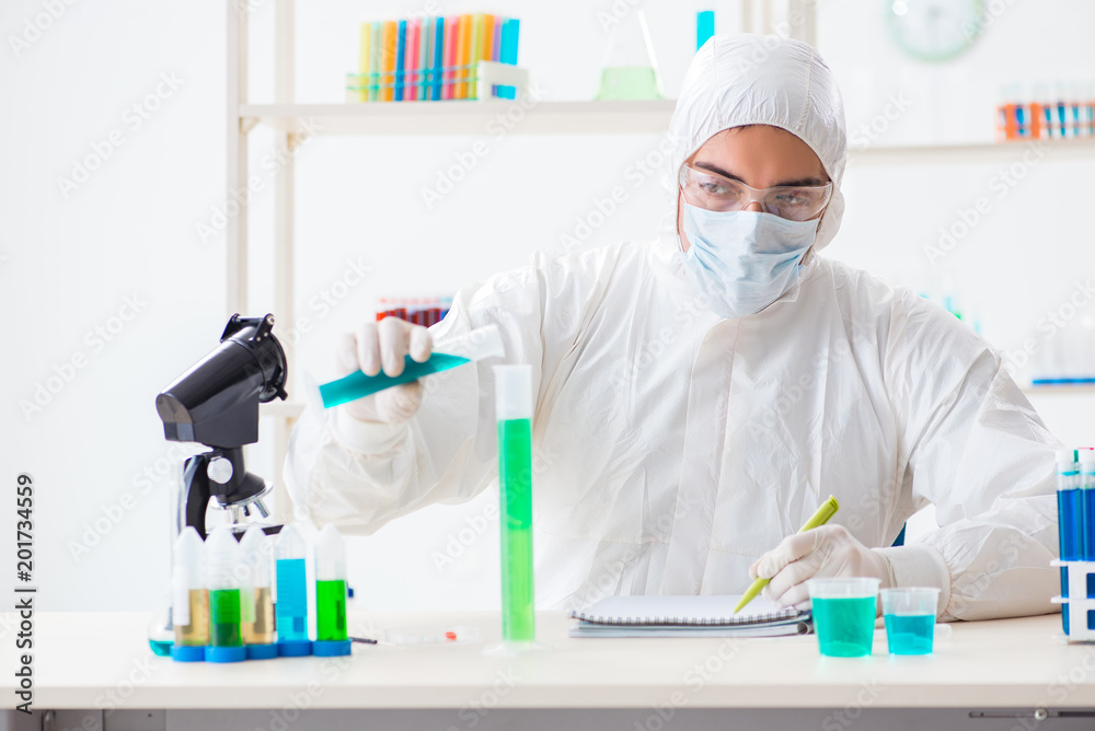 Young chemist student working in lab on chemicals Young chemist student working in lab on chemicals