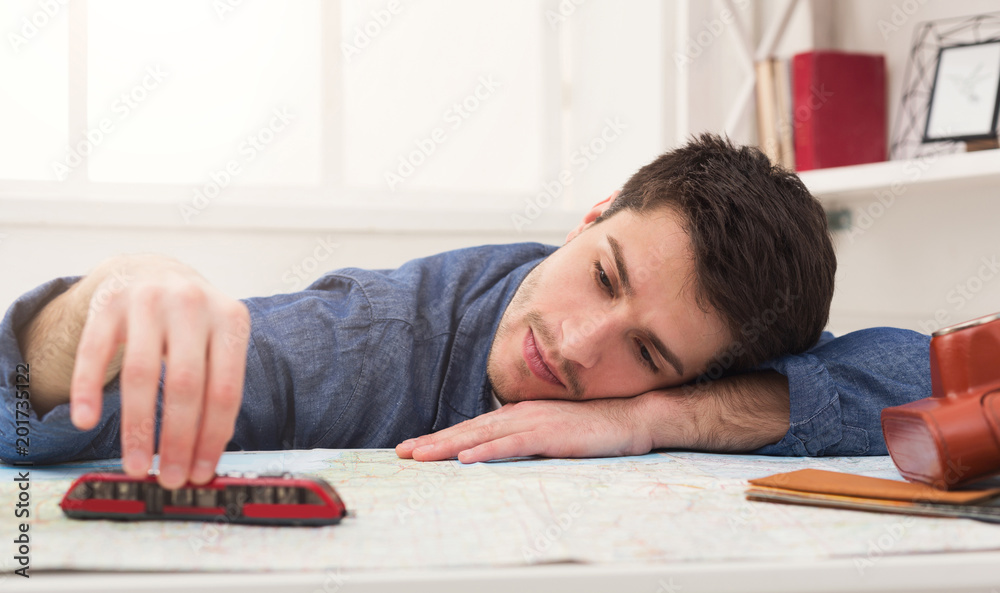 Man dreaming about travel, looking at map Man dreaming about travel, looking at map