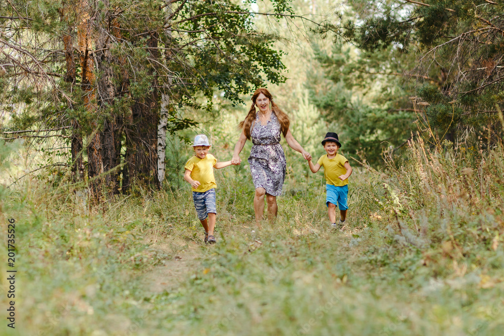 grandmother with two grandsons running in the Park