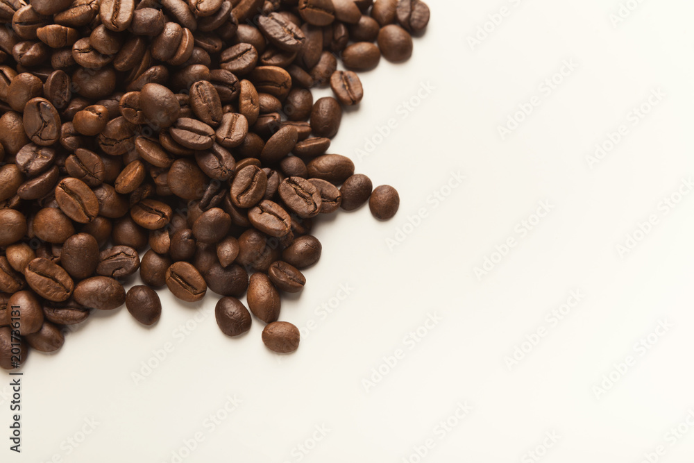 Heap of brown coffee beans isolated on white Heap of brown coffee beans isolated on white