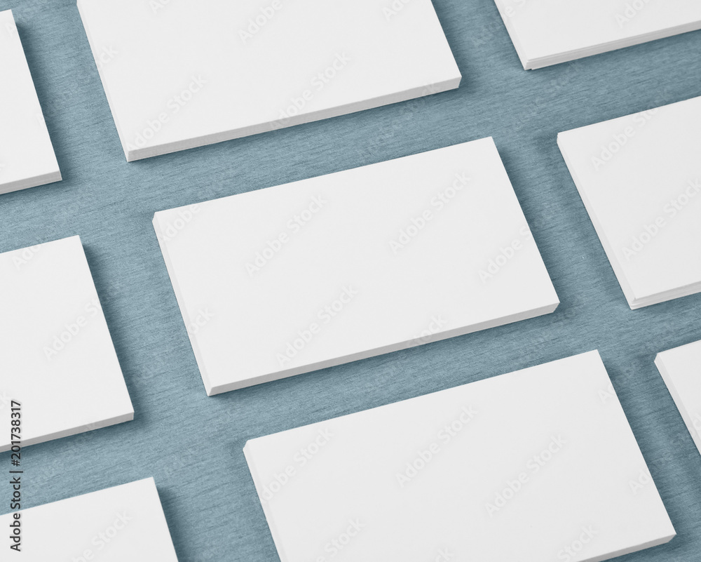 Obraz premium Mockup of horizontal business cards stacks arranged in rows at gray textured background.
