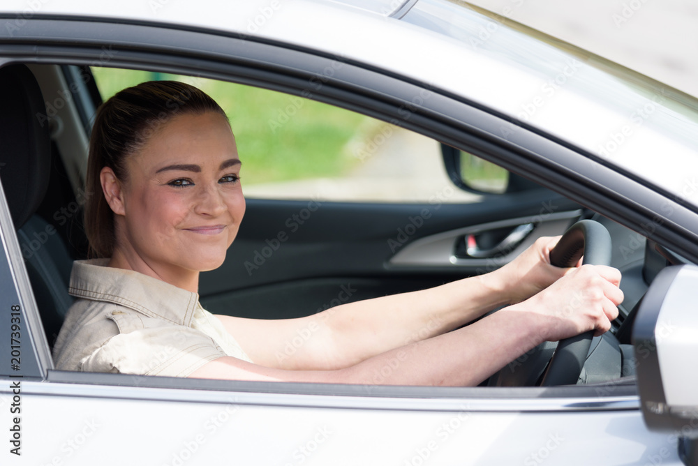 Side View Of A Young Happy Woman Driving Car