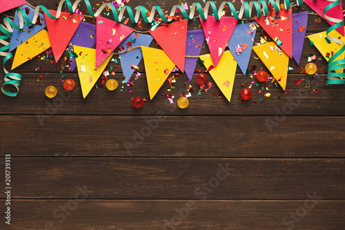 Colorful flags garland on wooden background