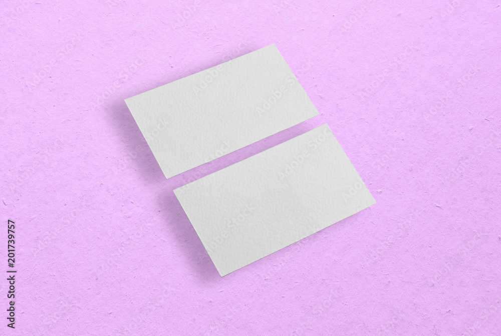 Mockup of two horizontal business cards at pink background.