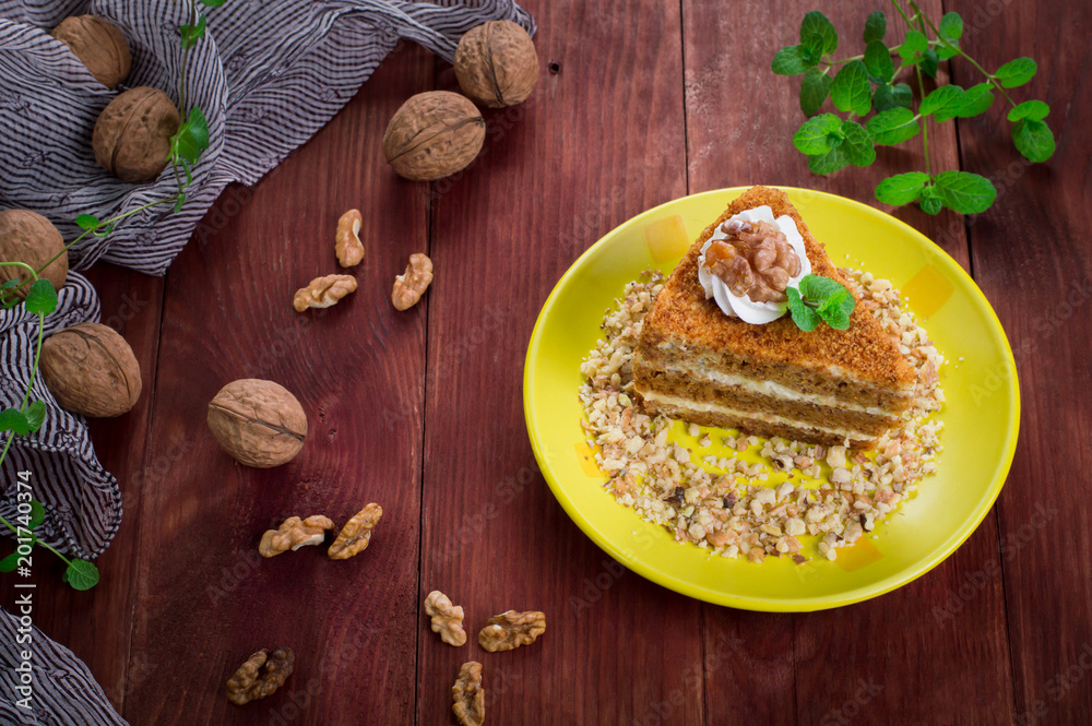 Honey cake on a plate. Wooden rustic background