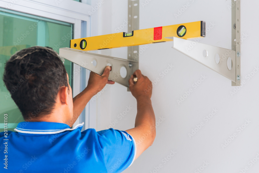Technicien using Clinometer Bubble Level Ruler tool to install rack for straight and balance Technicien using Clinometer Bubble Level Ruler tool to install rack for straight and balance