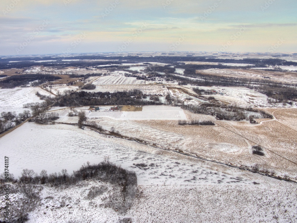 Rural Farmland during Winter in Minnesota seen from above by Drone