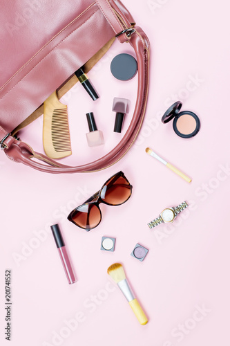 Woman bag stuff flat lay. Beauty accessories, purse, sunglasses, travel concept.