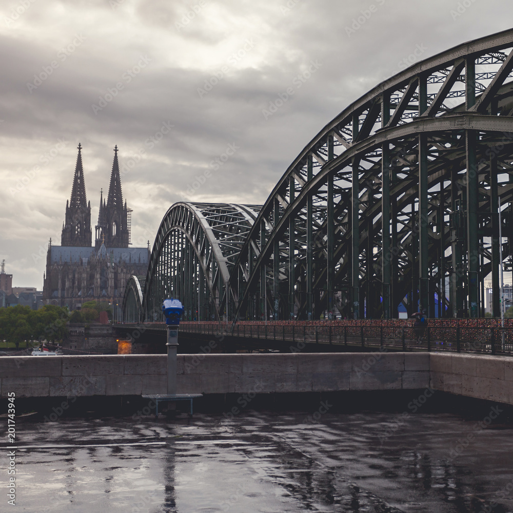 View on Cologne Cathedral and Hohenzollern Bridge, in the rain. Germany. Panorama of the city