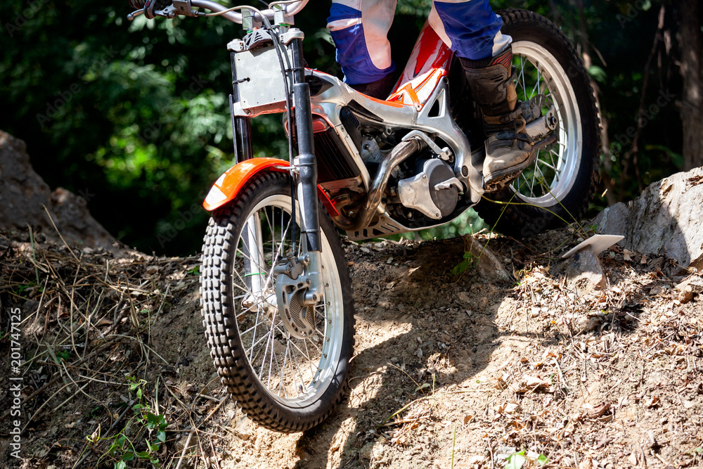 Trials motorcycle while competition in nature park, close up shot Trials motorcycle while competition in nature park, close up shot