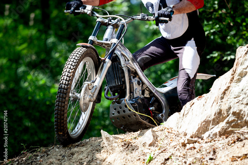 Trials motorcycle while competition in nature park, close up shot