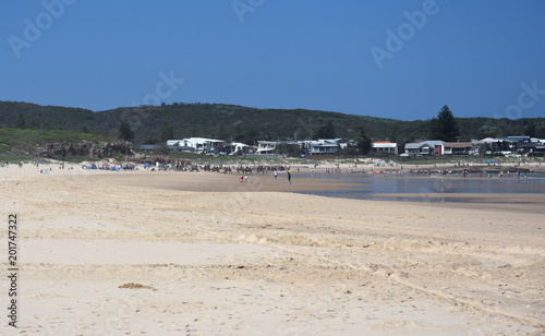 Tourist riding camel on Birubi beach (NSW, Australia). With soft, silky sand at the beaches, the environment is perfect for camel riding. © katacarix