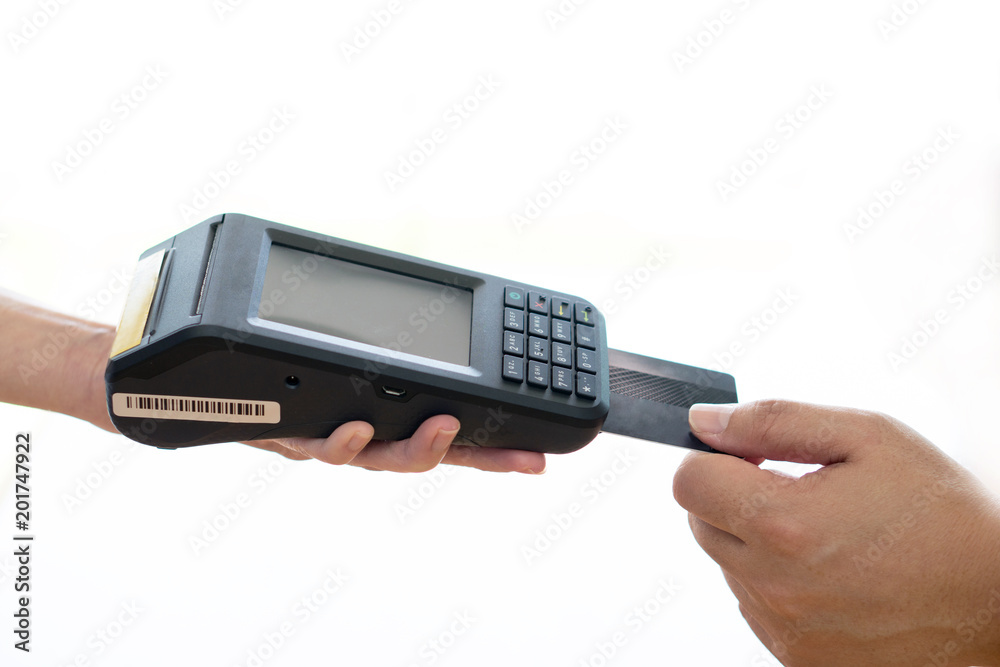Woman placing credit card into reader Woman placing credit card into reader