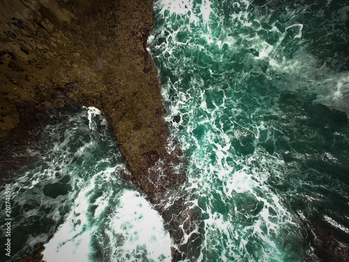 Aerial view of sea waves crash on the shoreline. Portuguese coastline