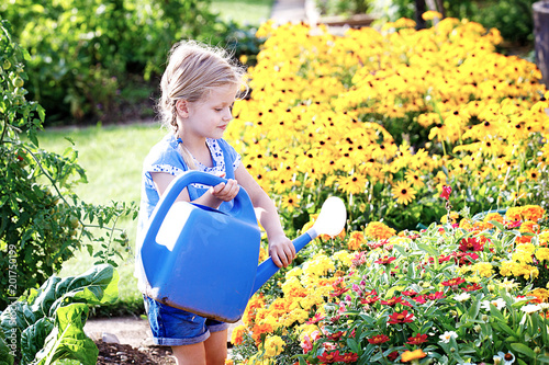 Child is watering flowers