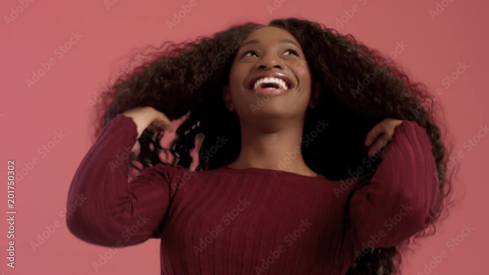 Beauty black mixed race african american woman with long curly hair and laughing. Happy laughing black woman