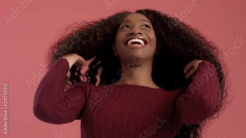 Beauty black mixed race african american woman with long curly hair and laughing. Happy laughing black woman