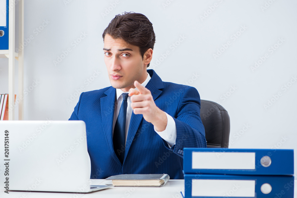Young handsome businessman employee working in office at desk Young handsome businessman employee working in office at desk