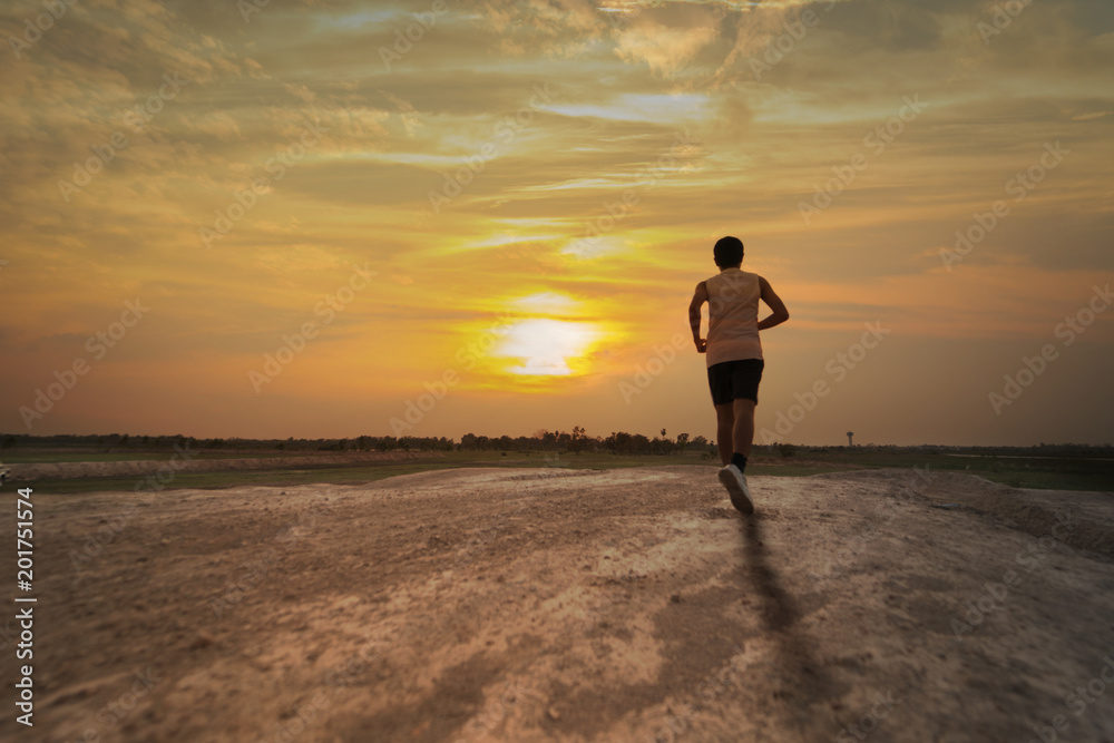 man running with sunset or sunrise