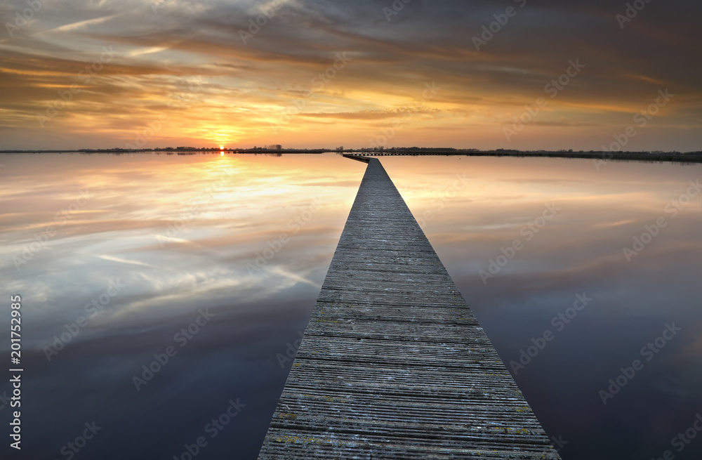 long walkway on big lake at sunset