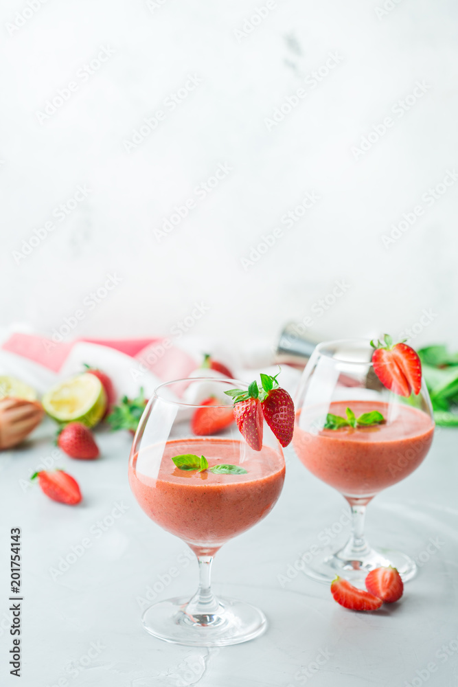 Alcohol cocktail with vodka, strawberry, lime, basil and ice Alcohol cocktail with vodka, strawberry, lime, basil and ice
