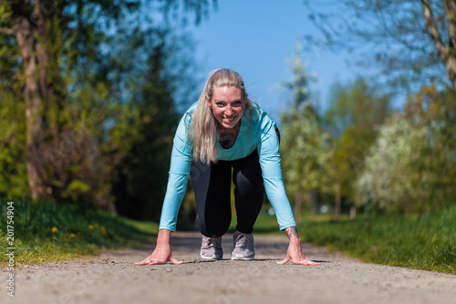 Young woman is stretching in a sport dress