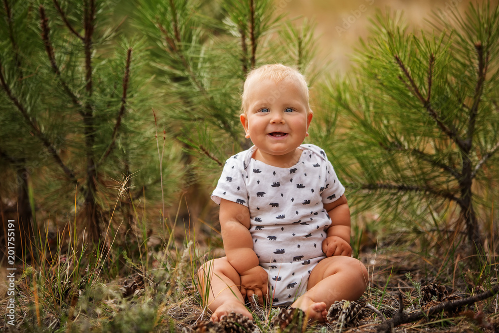 Portrait of a baby boy in green pine forest Portrait of a baby boy in green pine forest